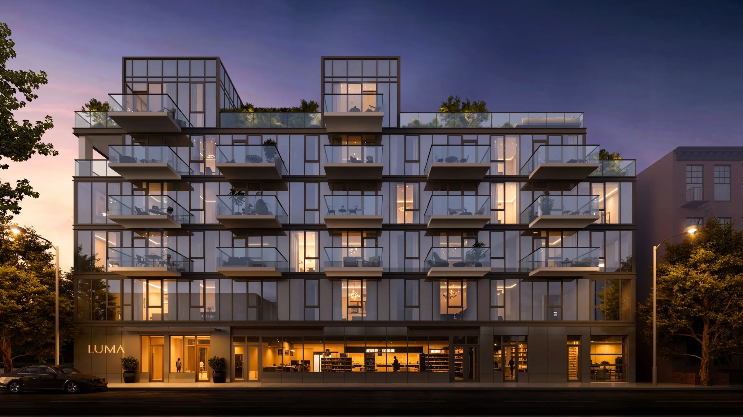 Rendering of LUMA at dusk — the lit glass facade and stacked balconies above the entry